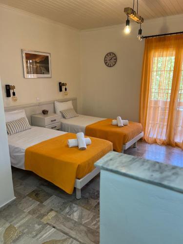 a room with two beds and a counter in it at Biscoutsis Apartments & Studios in Kavos