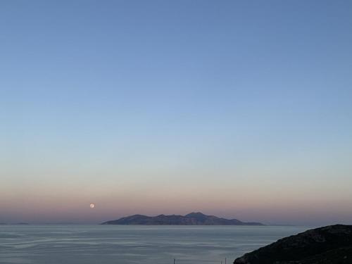a sunset over the ocean with mountains in the background at Chez Semiramis The Sun Touch House for 8 persons 5'min from the beach in Rámos