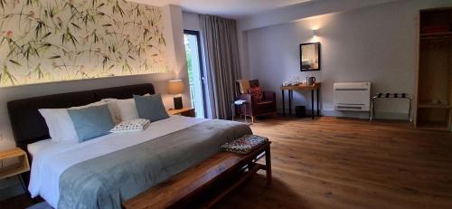a bedroom with a large bed with a large painting on the wall at Mili's B&B Guest House in Gabrovo