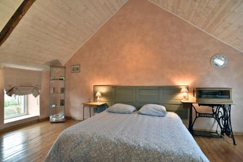 a bedroom with a large bed and a desk at Les gites du buisson in Fréhel