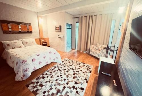 a bedroom with a bed with a checkered rug at Pousada Chateau Bella Vista in Campos do Jordão