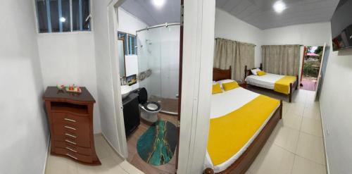 a small bedroom with a bed and a bathroom at La melosa in Girardot