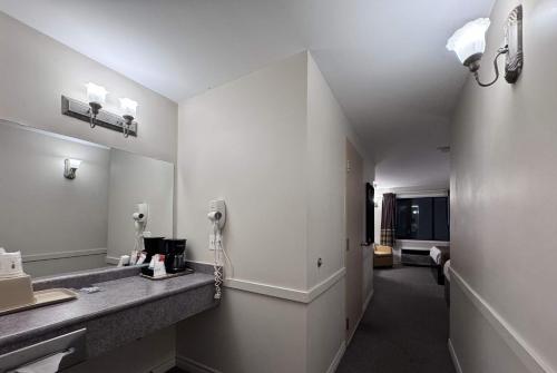 a bathroom with a sink and a mirror at Super 8 by Wyndham Guelph in Guelph