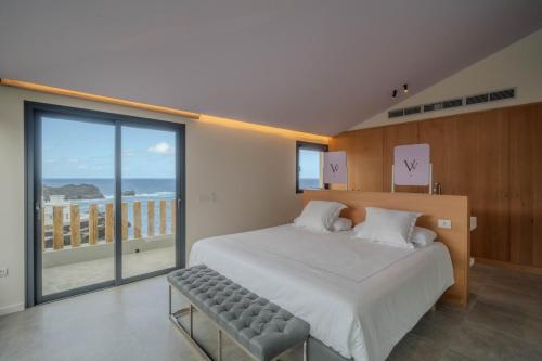 a bedroom with a large bed and a large window at Villa Vista Suite by Aura Collection in Tamaduste