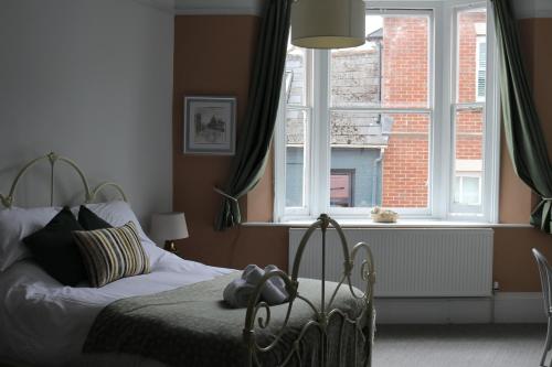 a bedroom with a bed in front of a window at Beds at 46, Cowes in Cowes