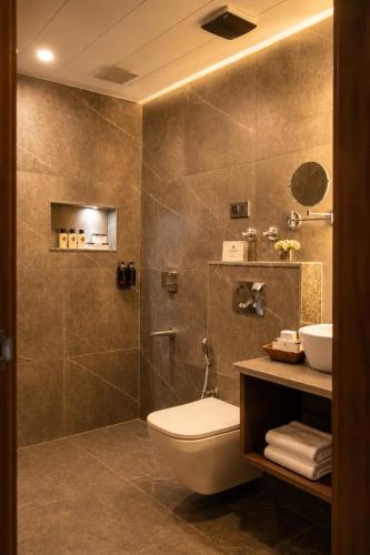 a bathroom with a toilet and a sink at Alasha Retreat in Srinagar