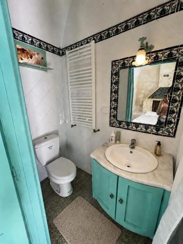 a bathroom with a toilet and a sink and a mirror at Casa Giallo Kelibia - Traditional charm in Kelibia