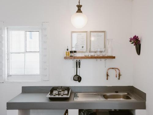 a kitchen with a sink and a counter top at Bonne Esperance, Simon's Town in Simonʼs Town