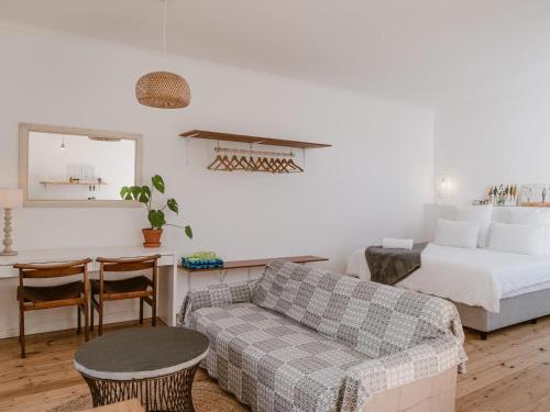 a living room with a bed and a couch at Bonne Esperance, Simon's Town in Simonʼs Town