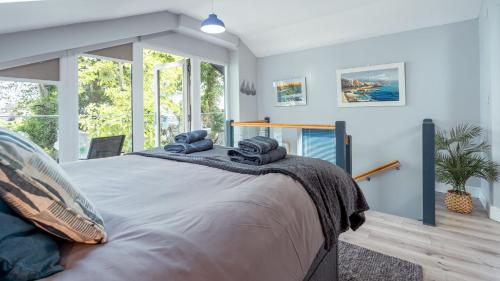 a bedroom with a large bed with blue walls at Bilidowcar in Menai Bridge