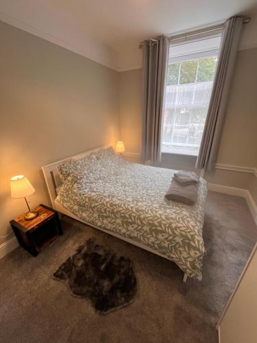 a bedroom with a bed and a large window at Stunning 2 bed apartment - central Norwich in Norwich