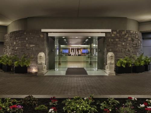 a lobby of a building with some plants at Novotel Auckland Ellerslie in Auckland
