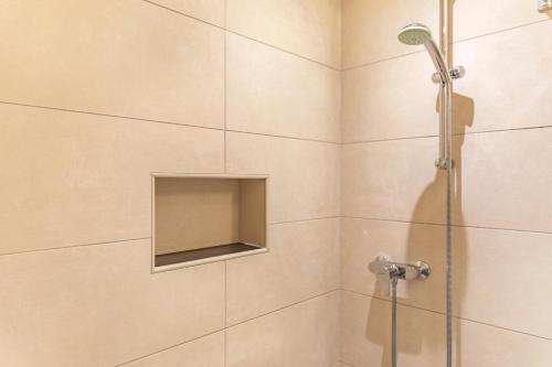 a shower with a glass door in a bathroom at Appartements Stockinger A1 in Grossarl