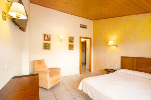 a hotel room with a bed and a chair at Ball de Diables in Sant Pau dʼOrdal
