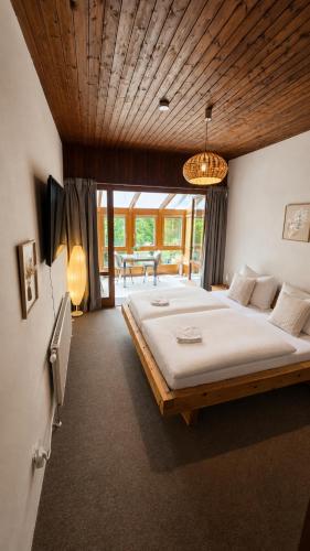 a large bedroom with a large bed in a room at Mountain View Room mit sonnigem Wintergarten in Dietmannsdorf bei Trieben
