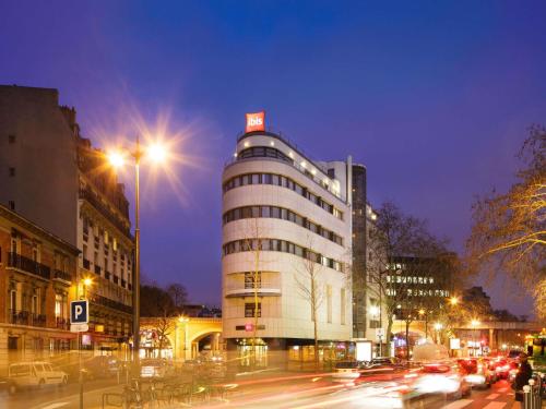 a building on a city street at night with cars at ibis Paris Gare de Lyon Diderot in Paris