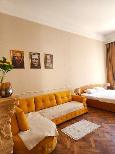 a living room with a couch and a bed at Gallery inn in Kutaisi