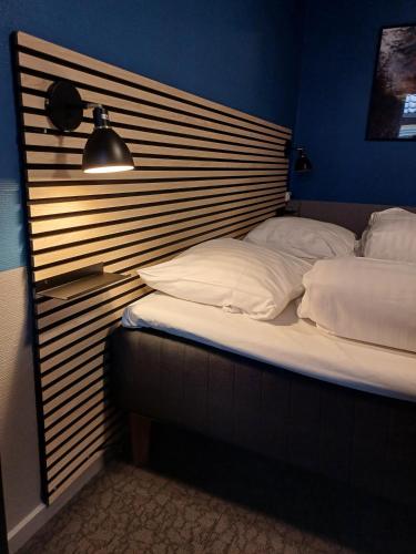 a bed with a wooden headboard in a room at Double Room 9 in Saeby in Sæby