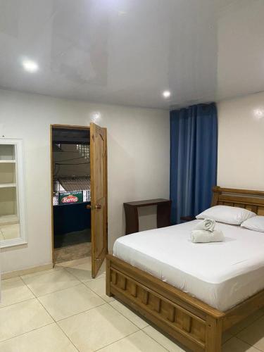 a bedroom with a large bed with a wooden frame at Miss Titi's Native Lodge in San Andrés