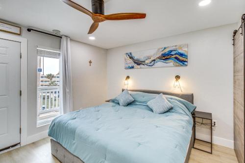 a bedroom with a bed and a ceiling fan at Unwind by the Beach | Pool and Oceanfront View in Corpus Christi