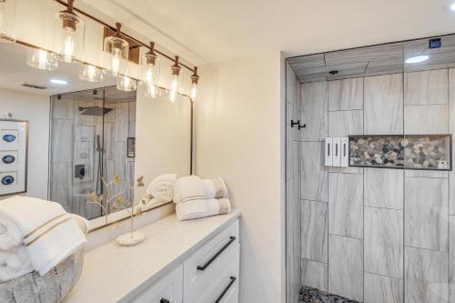 a bathroom with a large mirror and a shower at Unwind by the Beach | Pool and Oceanfront View in Corpus Christi