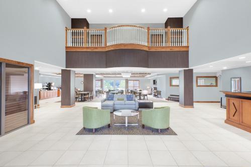 a lobby with a couch and chairs and a table at Wingate by Wyndham Sylvania-Toledo in Sylvania