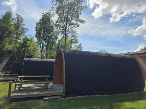 a pavilion with a picnic table and a bench at 43 Camping Pod "Molfsee" in Silberstedt