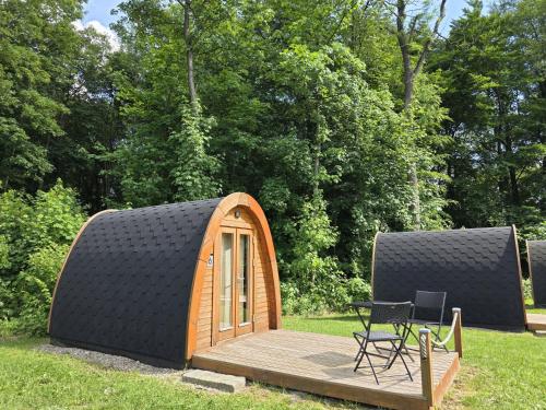 a small tent with a table and a chair on a deck at 36 Mini Pod "Sorge" in Silberstedt