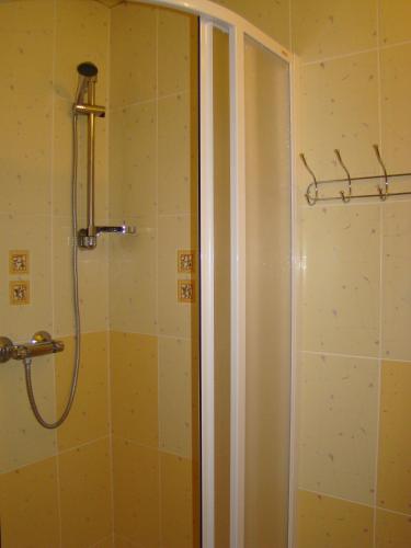 a shower in a bathroom with a shower curtain at Penzion Cabák in Vrchlabí