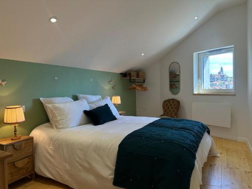 a bedroom with a large bed and a window at Maison Fontanille in Le Puy-en-Velay