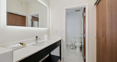a white bathroom with a sink and a toilet at Best Western PLUS Hannaford Inn & Suites in Cincinnati