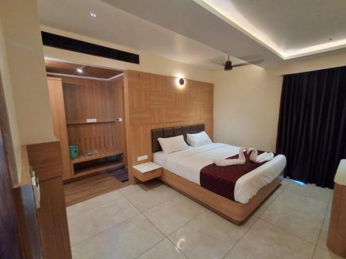 a bedroom with a large white bed in a room at Hotel Royal Stay in Madurai