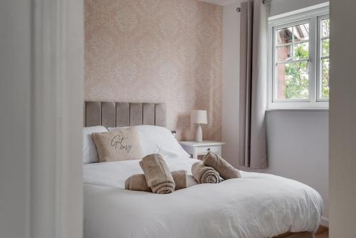 a bedroom with a white bed with pillows and a window at Recently Refurbished House Sleeps 5 near Stadiums in Liverpool