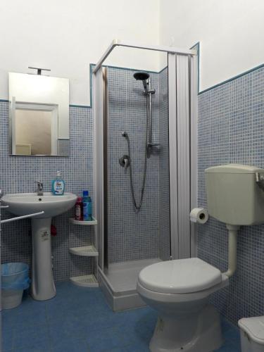 a bathroom with a shower and a toilet and a sink at Doribella Holiday House in Pollina