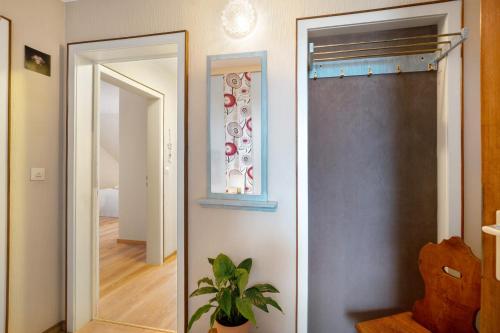 a hallway with a mirror and a door to a room at Apartment Abendrot in Freiamt
