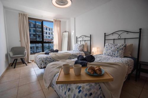 a bedroom with two beds with a tray of food on it at CASA VARGAS-TENERIFE in Los Cristianos