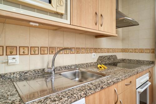 a kitchen with a sink and a counter top at Apartamentos Nerjaluna in Nerja