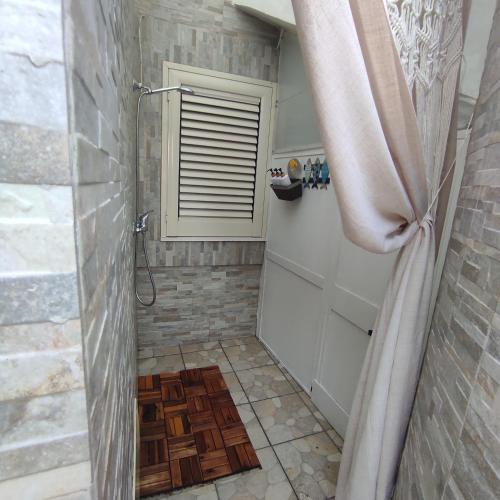 a bathroom with a shower with a shower curtain at casa MAREA in Lido Marini