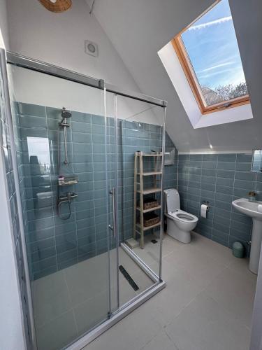 a bathroom with a glass shower and a toilet at Sea View Private Villa in Batumi