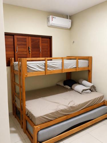 a bedroom with two bunk beds in a room at Casa Nordestina in Nísia Floresta