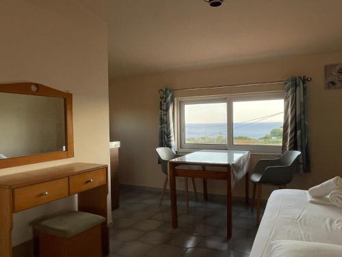 a hotel room with a table and a window at Andreas Studios in Svoronata