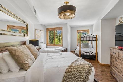 a bedroom with a bed and a living room at Rundle Cliffs Lodge by Canmore Premier in Canmore