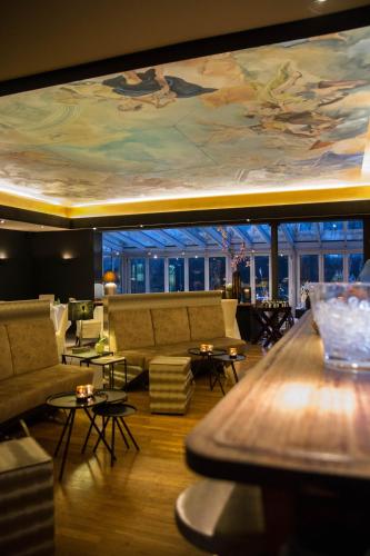 a hotel lobby with a painting on the ceiling at SeeHotel Ketsch in Schwetzingen