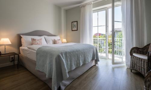 a bedroom with a bed and a large window at The Little Guesthouse in Salzburg
