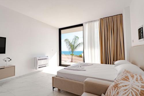 a bedroom with a bed and a view of the beach at SeaScape Residence in Borsh