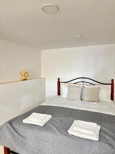 a bedroom with a bed with two towels on it at Phoenix - Rise and Relax in Agia Galini