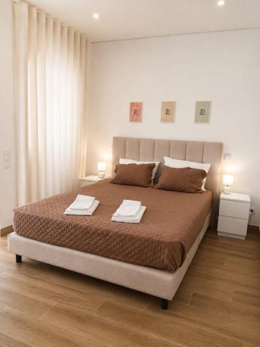 a bedroom with a large bed with two towels on it at Casa Rabiosa in Nazaré