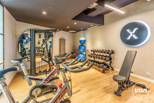 a gym with a bunch of bikes in a room at ViVi Homes - Marisol Pool, Sauna, Gym, Spa & Beach in Mijas Costa