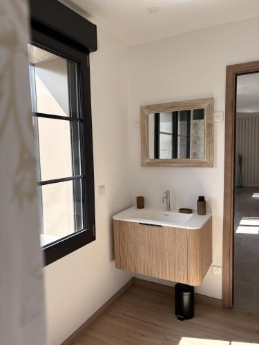 a bathroom with a sink and a window at Gite Ô’Violetis in Domvast