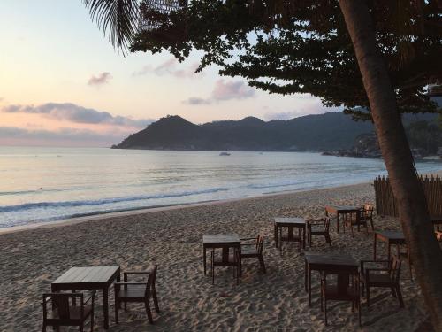 a group of tables and chairs on a beach at Sand in My Shoes Beach Loft in Thong Nai Pan Noi